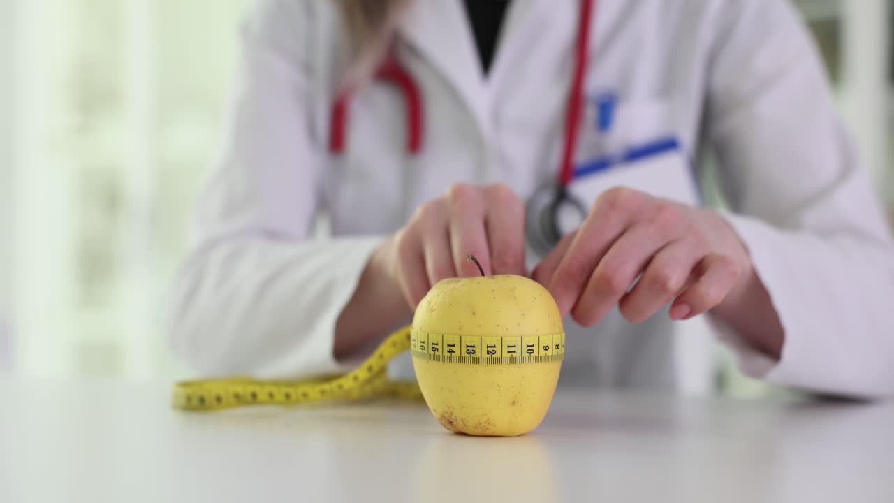A doctor or nutritionist measuring an apple with a tape measure, symbolizing diet and health