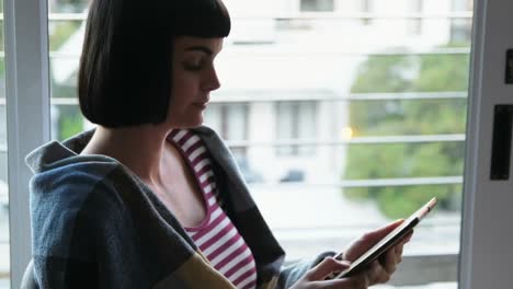 woman using digital tablet in living room 4k