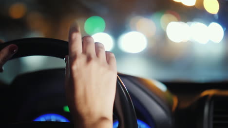 a woman's hand nervously drummed on the steering wheel of the car stand in traffic uncertain driver