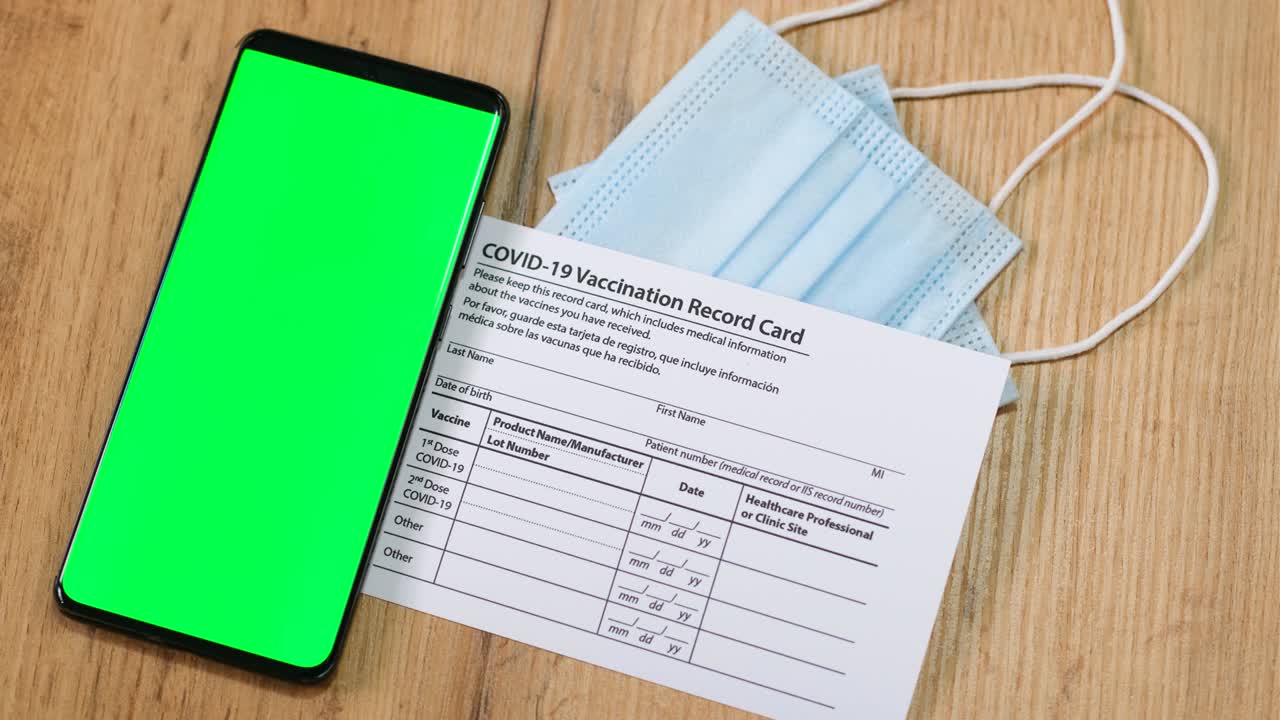Mock up green color smartphone empty space for digital app, health care. QR code scan and COVID-19. Personal code with encrypted info on the screen. Coronavirus vaccination card and medical mask