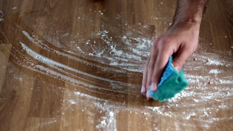 Scouring-Sponge-Magic:-Super-Close-Up-Slow-Motion-Flour-Cleanup-on-Table---4K-Footage