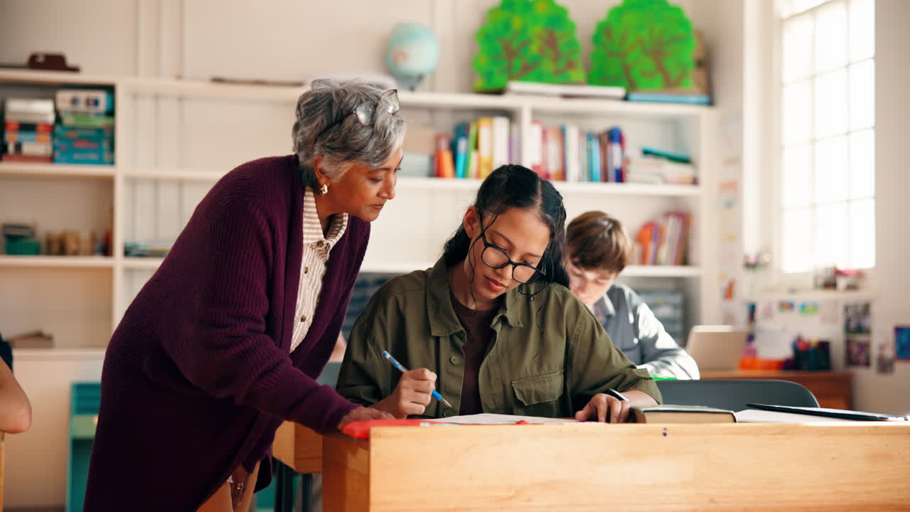 Teacher Assisting Student in Classroom