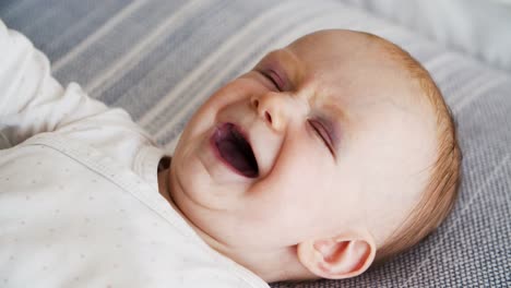 Closeup-of-positive-laughing-cute-red-haired-baby