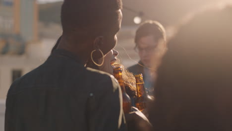 group of friends hanging out together enjoying rooftop party at sunset taking selfie photos using smartphone drinking alcohol having fun on weekend sharing celebration