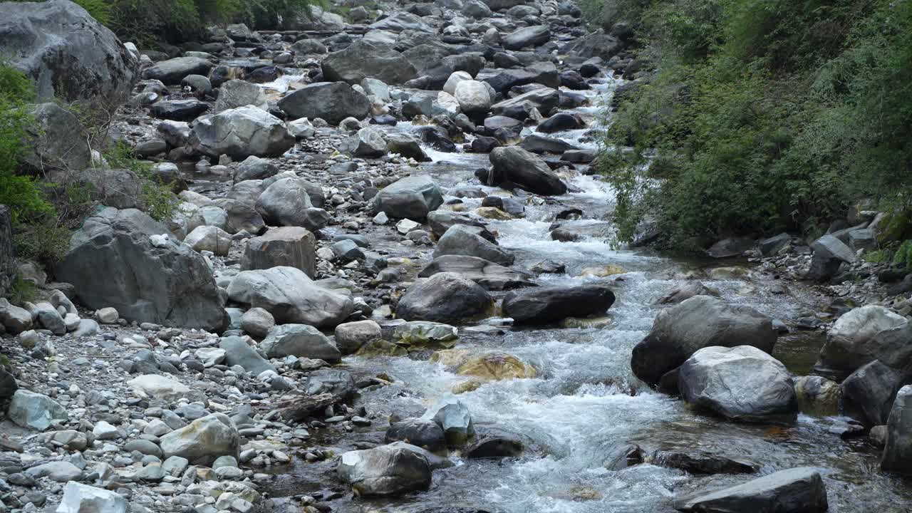 Water is flowing through a mountain torrential river.