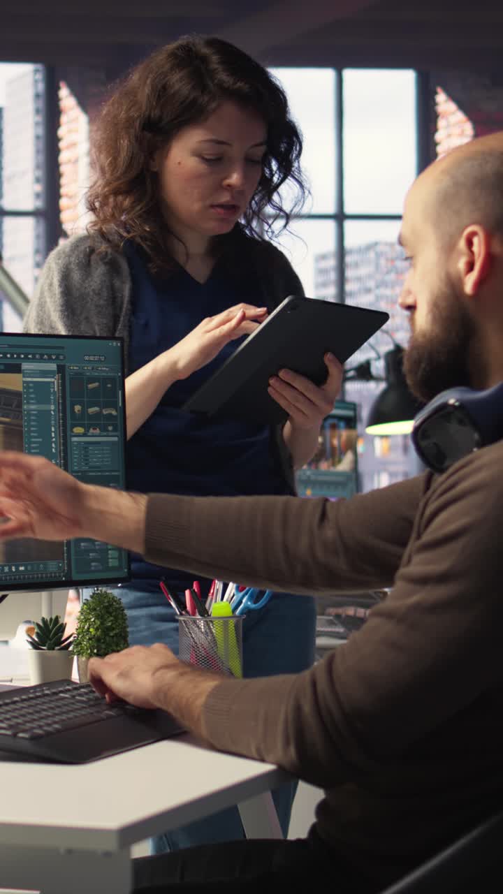 Vertical Video Architectural design team configures a floor plan on dual monitors