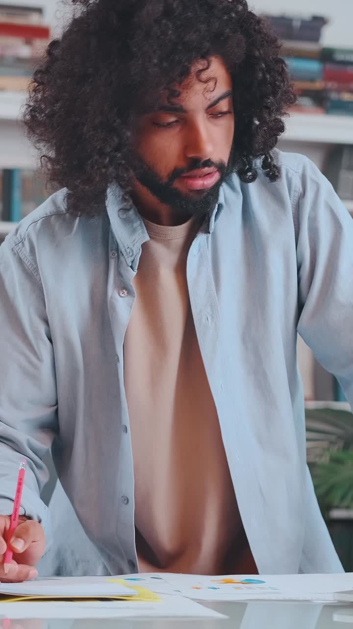 Creative artist sketching in a cozy studio surrounded by vibrant materials