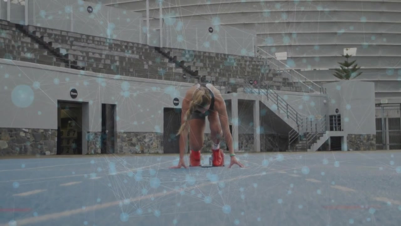 female athlete planting into red blocks on track leaning forward as animated lines aligning posture