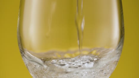 pouring sparkling water in a wine glass, bubbling water