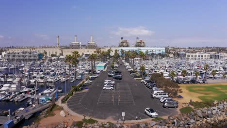 Close-up-rising-aerial-shot-of-the-long-parking-lot-dividing-King-Harbor-Marina-in-Redondo-Beach,-California