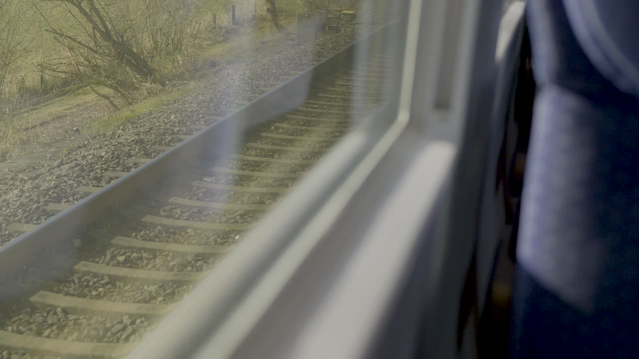View from inside a moving German ICE train with rails visible through the window
