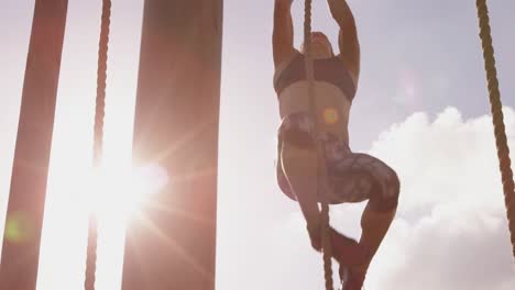 young woman training at an outdoor gym bootcamp