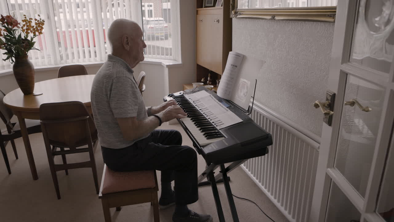 Elderly man playing piano at home
