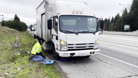 Changing-the-tire-of-a-trailer-stranded-on-the-road