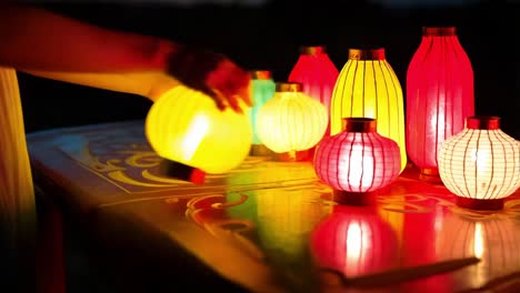 woman admiring colorful lanterns at night