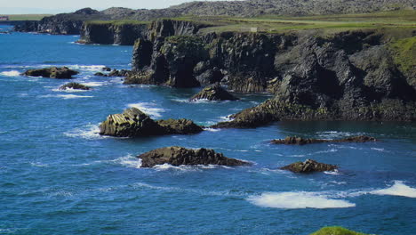 slow motion footage of sea waves on coast line with cliffs and rocks in arnarstapi village in iceland on snaefellsnes peninsula