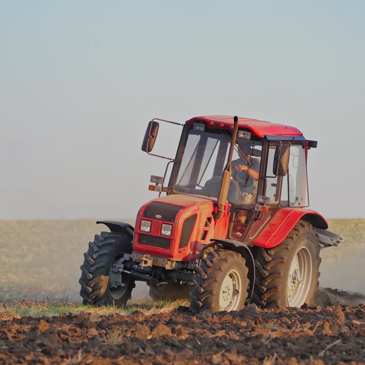 Tractor plows a field