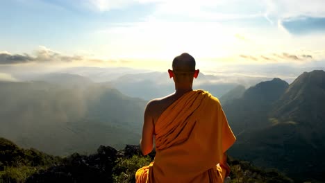 monk meditating on a mountaintop at sunrise