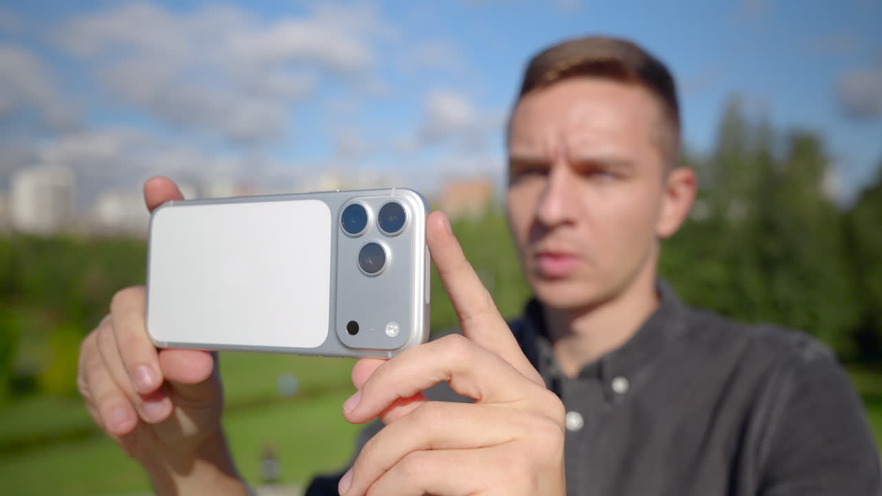 Man taking a selfie with smartphone in the park