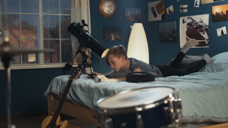 teenager gaming in bedroom