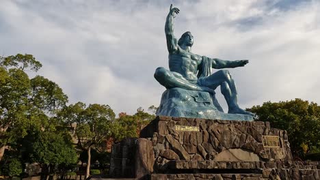 Slide-along-the-Peace-Statue-in-Nagasaki-Peace-Park,-Nagasaki,-Japan