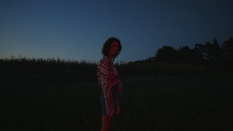 woman in a field at dusk