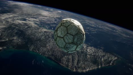 old soccer ball in space on earth orbit