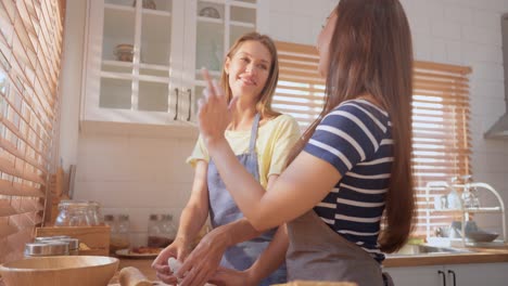 two friends baking together in the kitchen