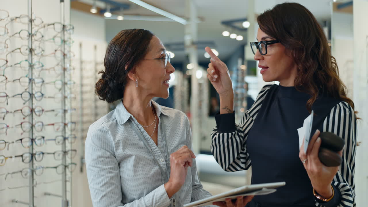 optiker hilft einem kunden, eine brille zu wählen