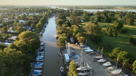 Aerial-parallax-shot-rising-over-canals-in-San-Isidro-city-in-Buenos-Aires-at-golden-hour