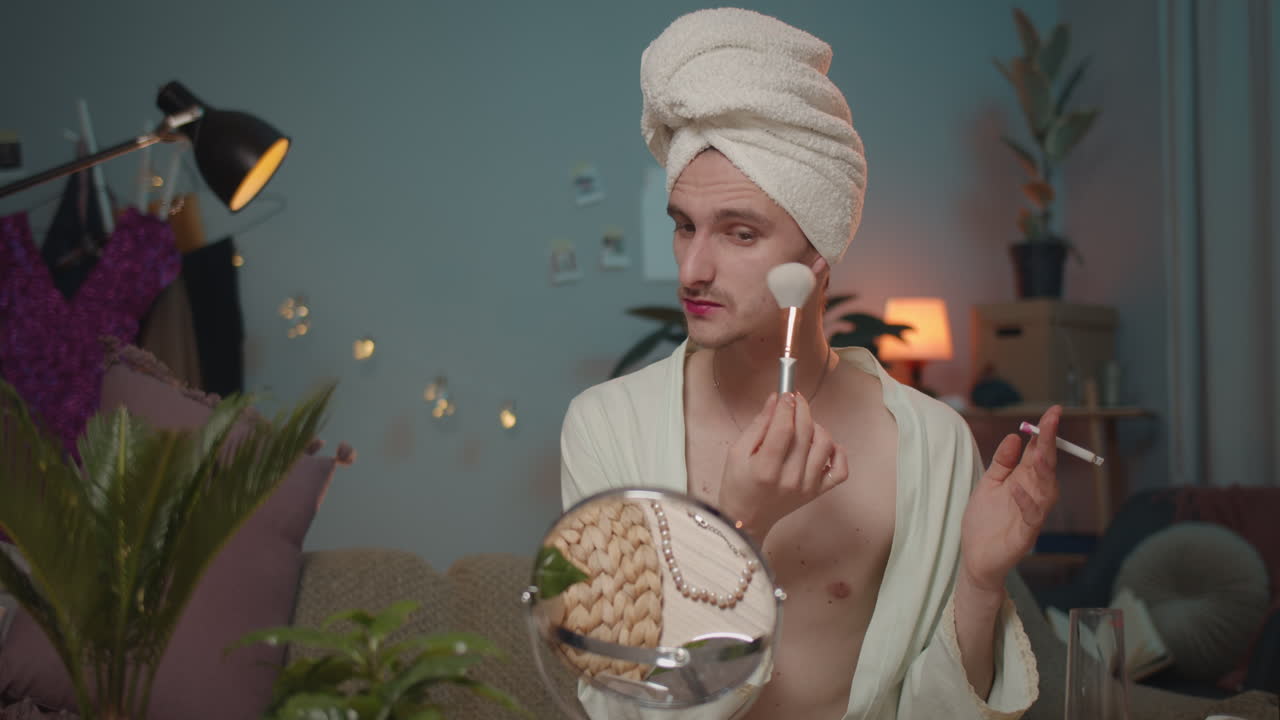Man applying makeup while smoking cigarette