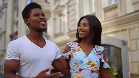 afro couple having romantic date outdoors. man and woman walking in city