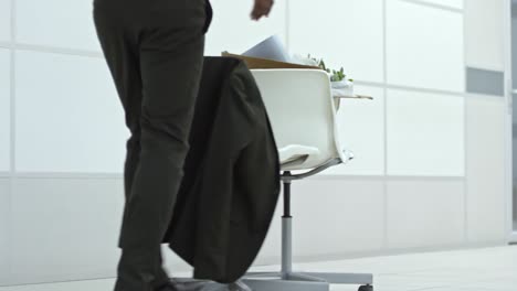 unrecognizable employee pushing office chairs to new workplace