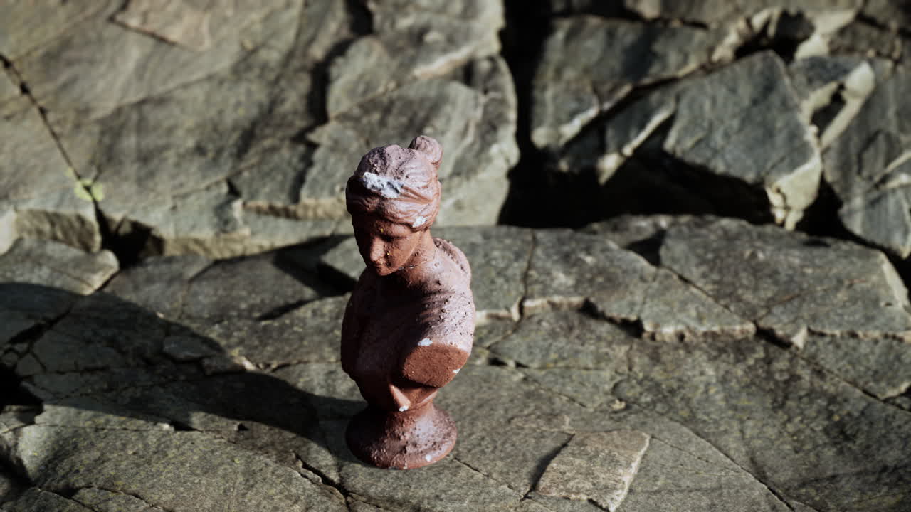 antigua estatua de mujer en piedras rocosas