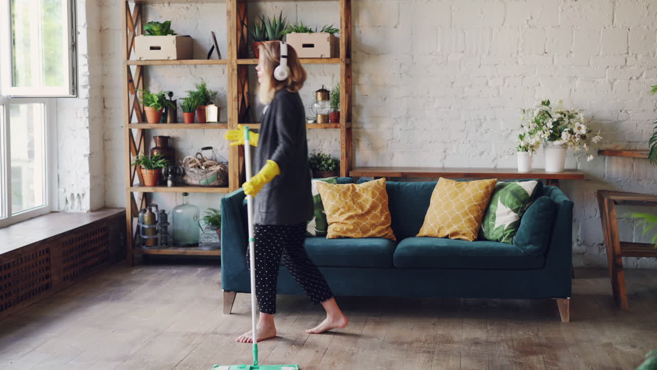 Woman Mopping the Floor in a Modern Living Room