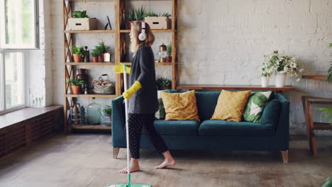 woman mopping the floor in a modern living room