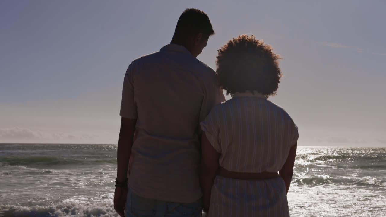 Back, love and a couple holding hands on the beach