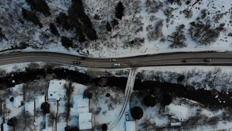 drone footage in snowy mountains as sun goes down