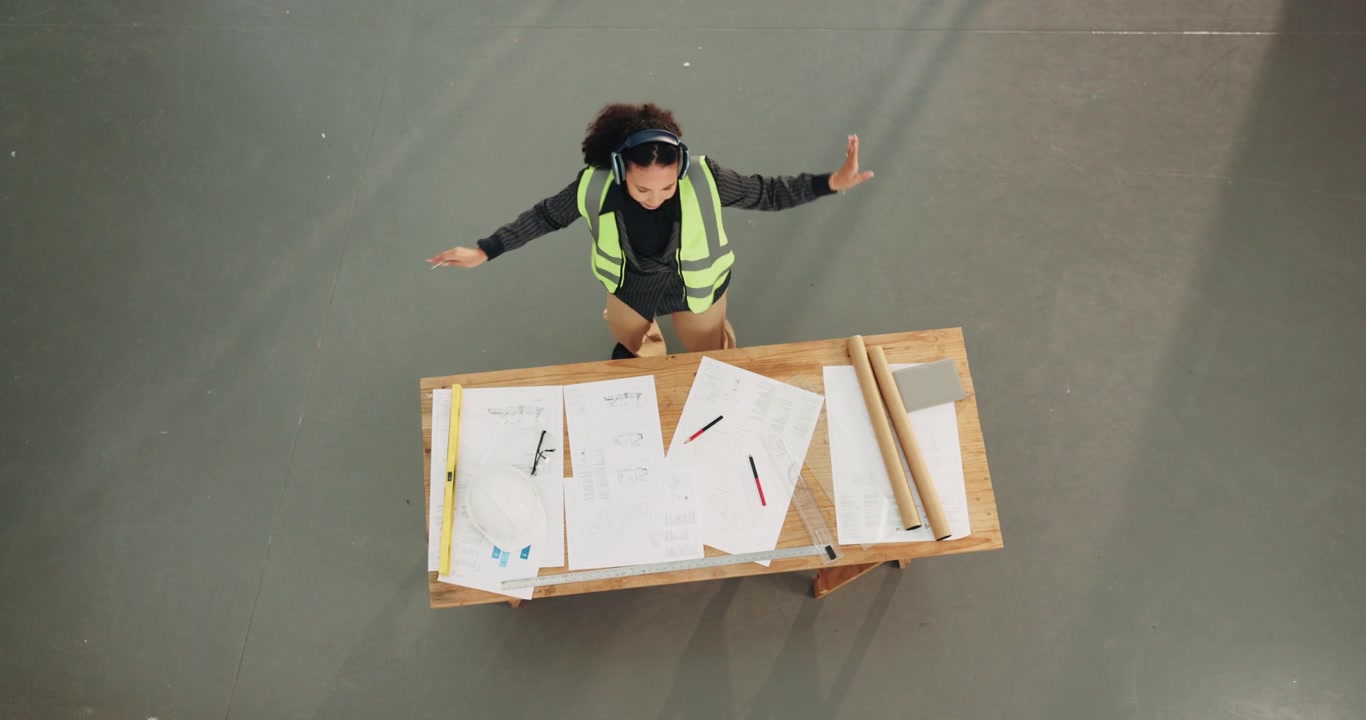 Female Architect Dancing While Reviewing Blueprints at Construction Site
