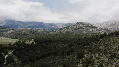 Smooth-and-slow-descending-aerial-over-the-Sierra-de-Guadarrama-mountain-ranges-near-Manzanares-el-Real-in-Spain