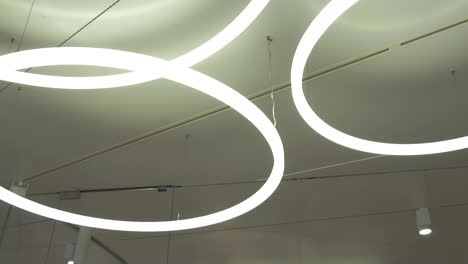 large circular loop lights glowing on the ceiling