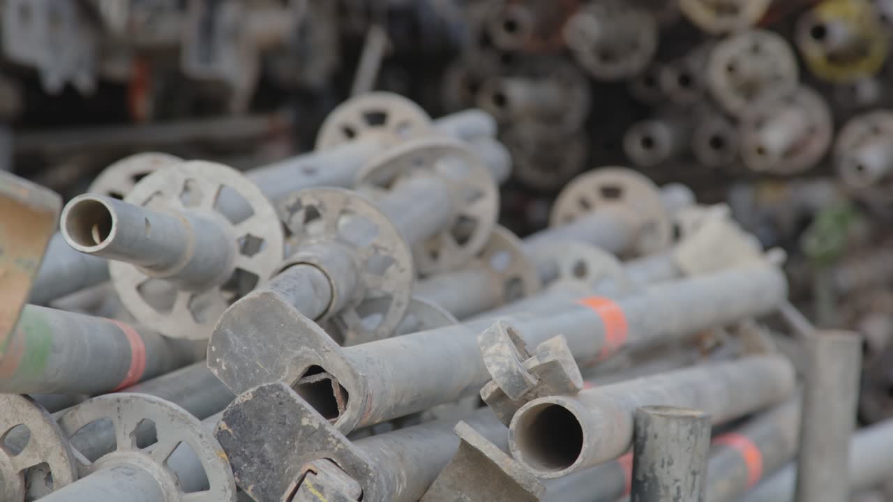 Focus rack of a lot of scaffold standards on an industrial worksite on a sunny day