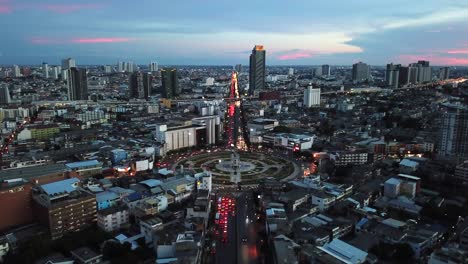 aerial view of city during sunset. flying over huge roundabout in bangkok, thailand