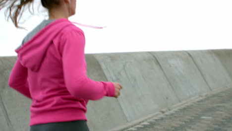 Sporty-woman-with-headphones-jogging