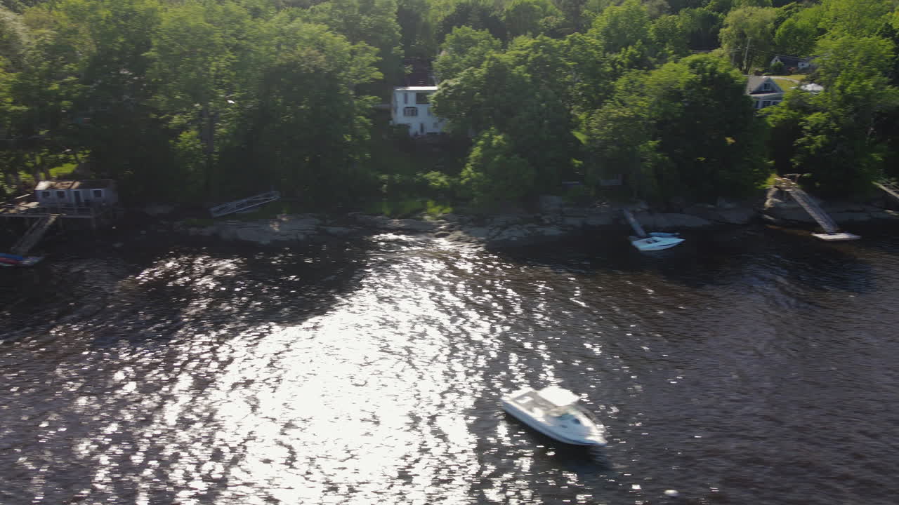 Sunny Waterfront Scene with Houses and Boats