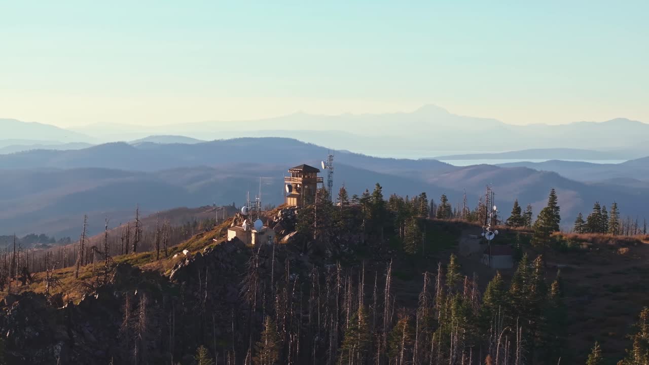 Scenic view of California fire lookout tower amidst mountains at sunset