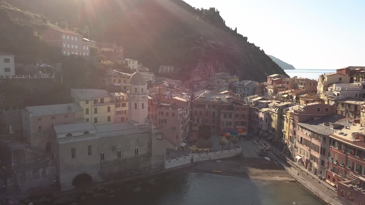 circulair droneshot of a coastline village in italy at sunrise 4k.
