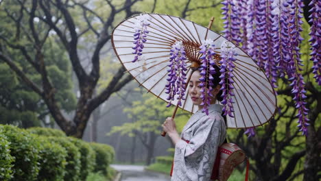 woman in kimono with wisteria and umbrella