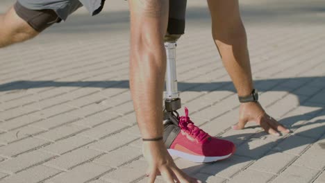 closeup of man with prosthesis doing stretching exercises.