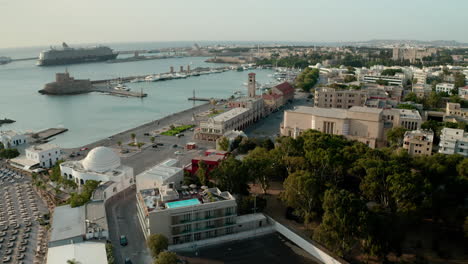 an aerial city view of rhodes island in greece containing clips of the medieval old town, the old lighthouse at the port, old windmills, beaches and amazing sunset